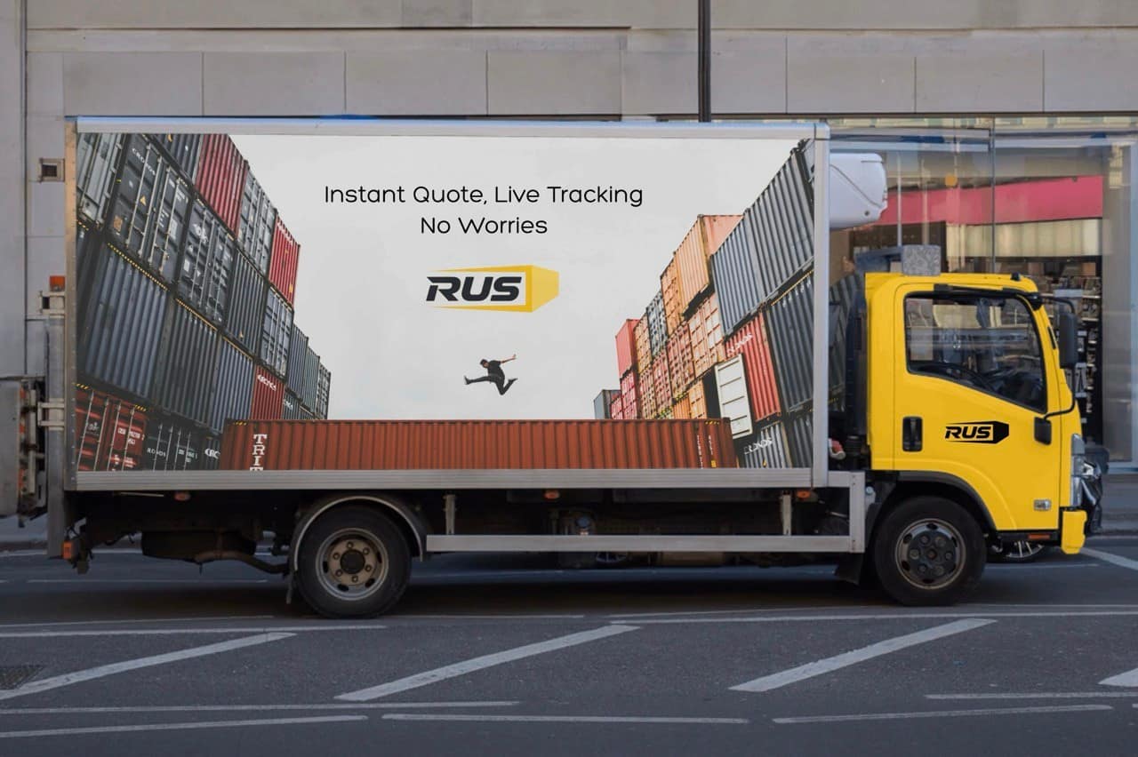RUS Logistics truck artwork with container branding in an urban street